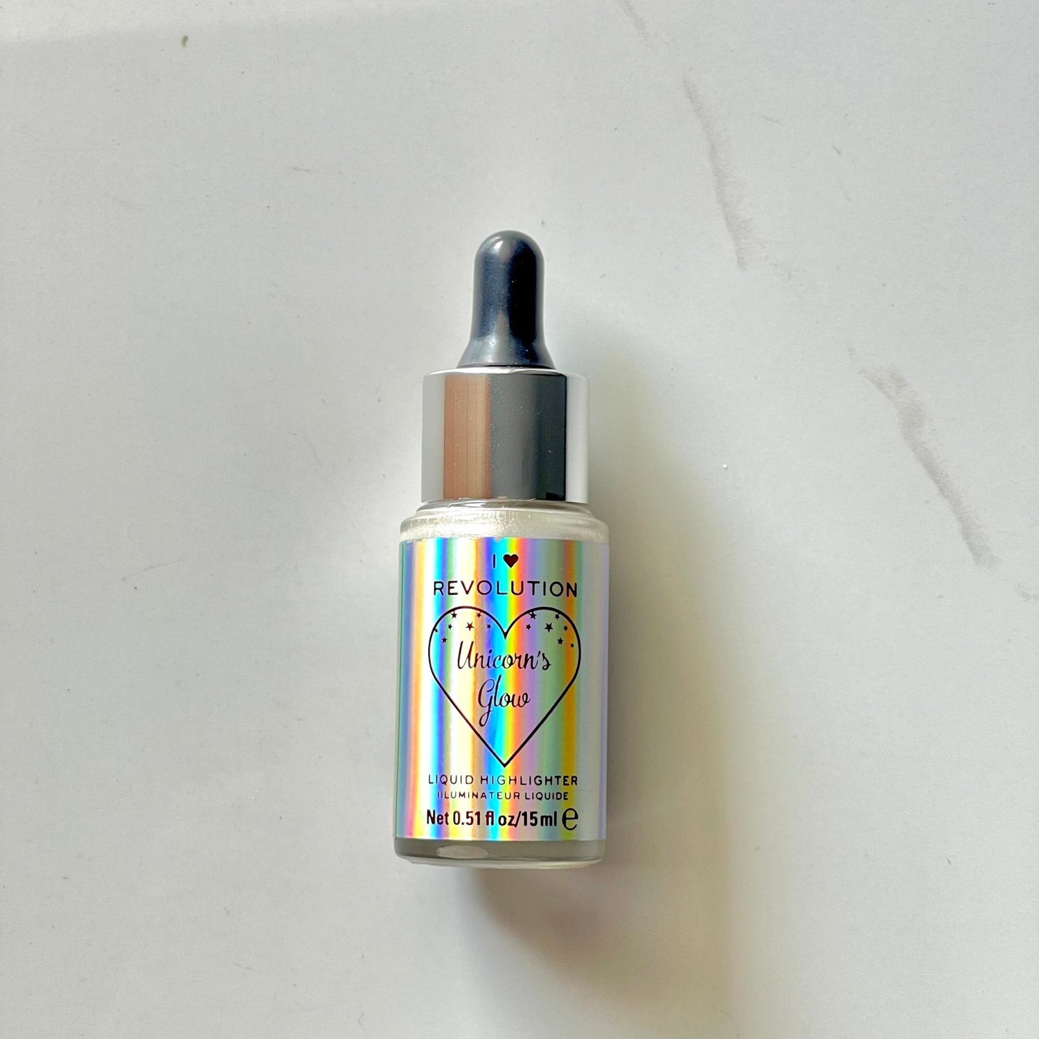 Revolution I Heart Liquid Highlighter Illuminator Glow Enhancing Drops for Radiant Skin — highlighter on white background